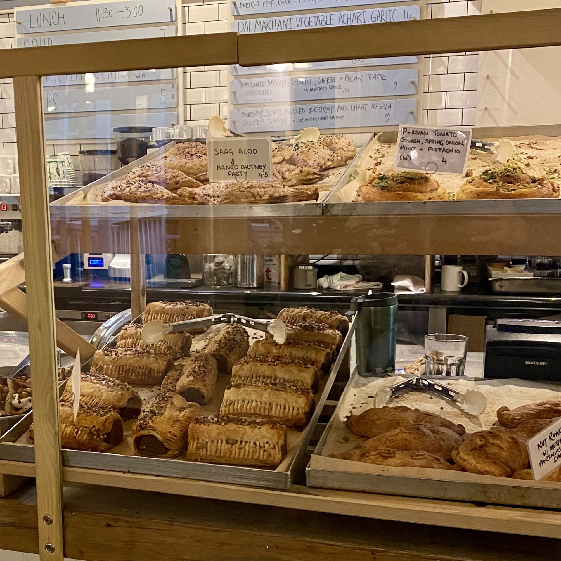 An assortment of pastries in a cafe for sale.