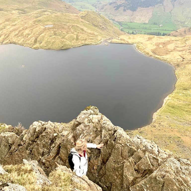 A woman standing on Jack's Rake overlooking Stickle Tarn.