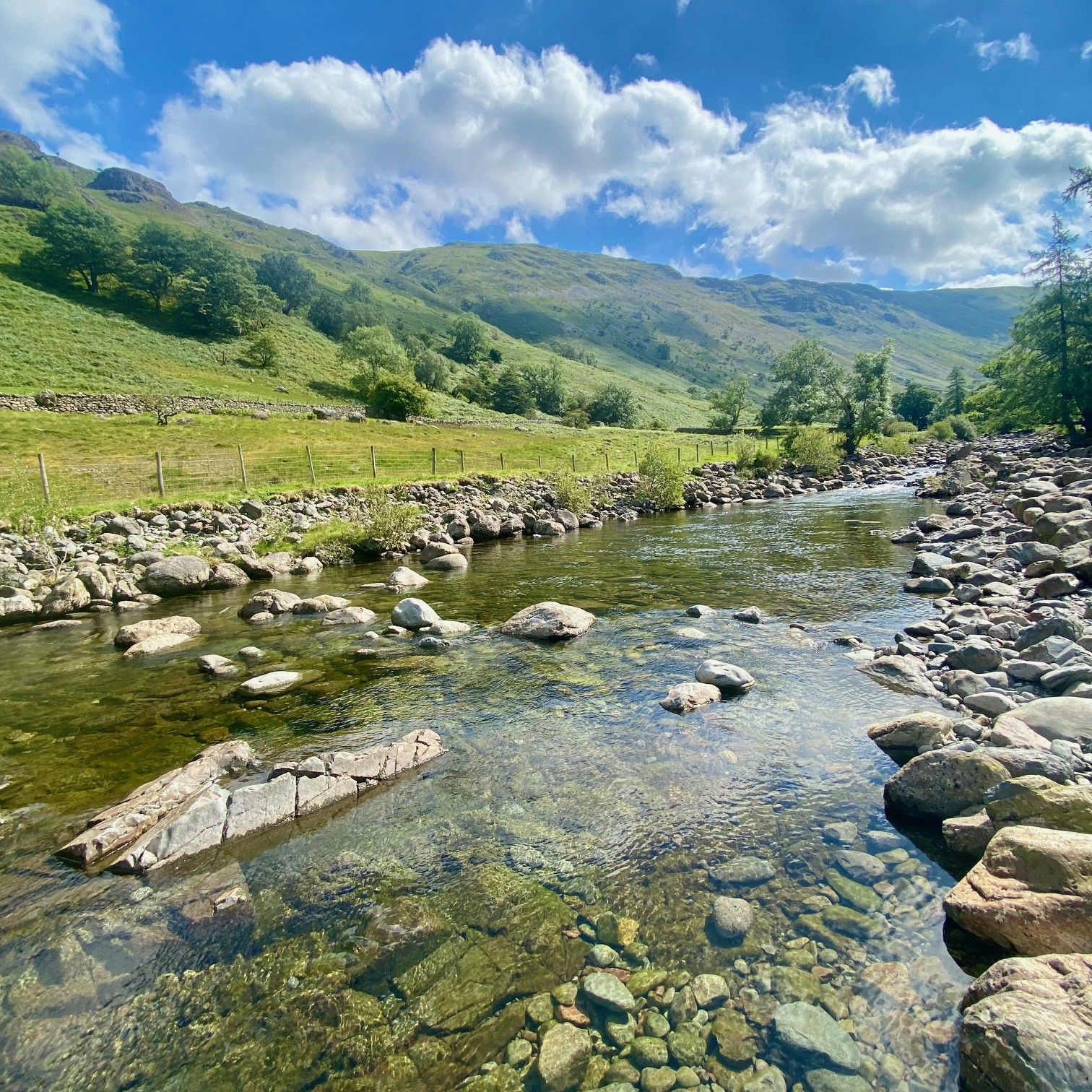 Stonethwaite Beck in The Lake District on a clear, sunny day. On the route to Black Moss Pot