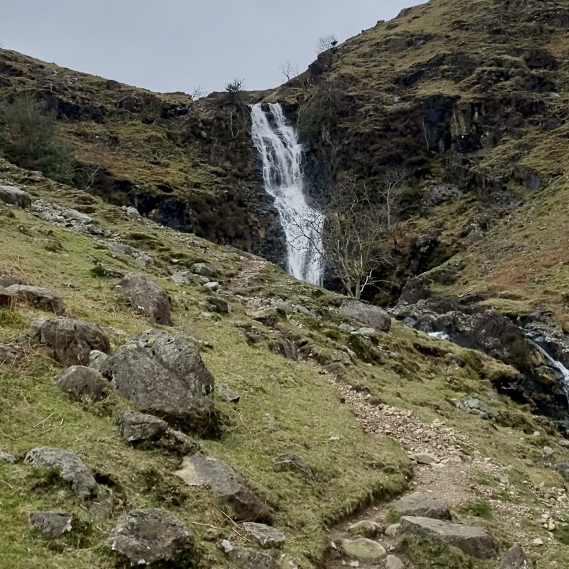A view of Whorneyside Force from a distance with a path leading up to it.