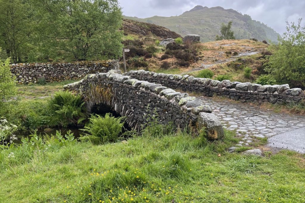 A grade II packhorse bridge made of slate rubble, in Watendlath