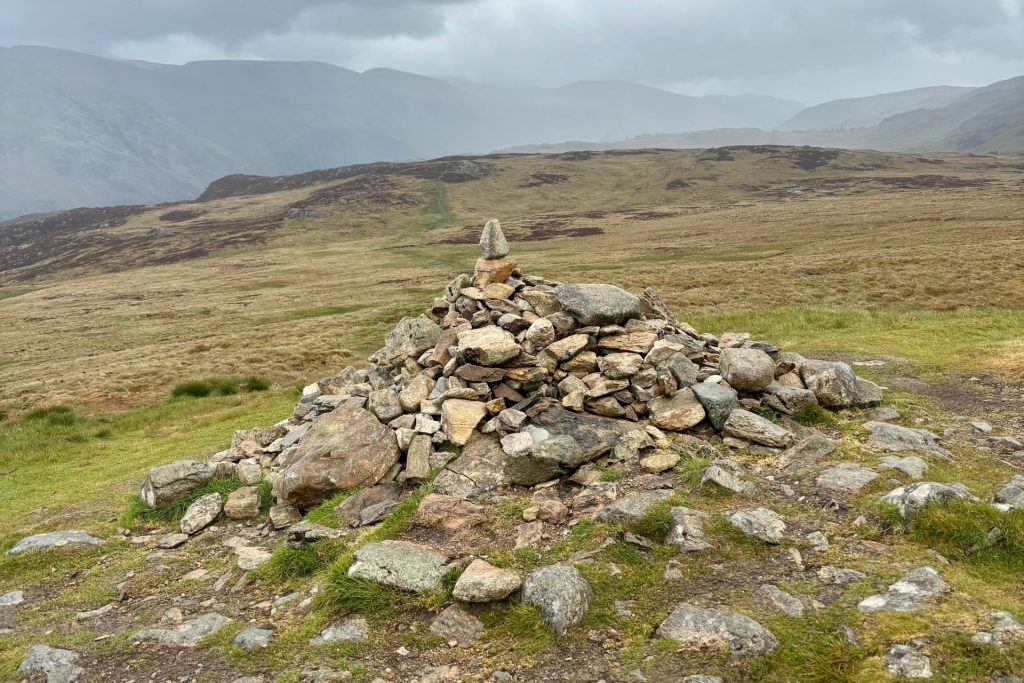 A cairn of stones indicating the summit of High Tove